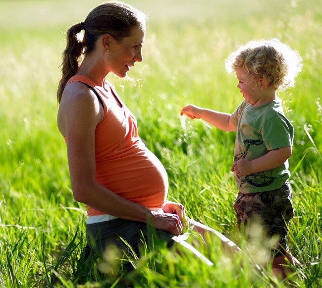 Pregnant mother playing with her kid